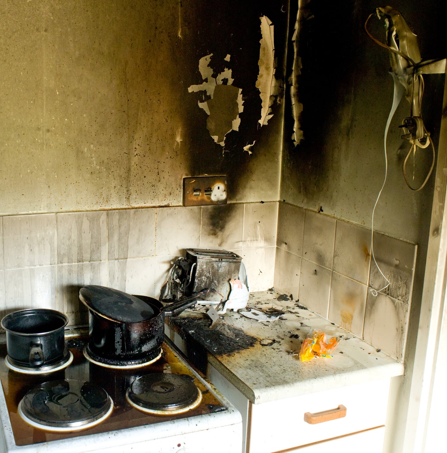 a dirty kitchen with a stove and a sink