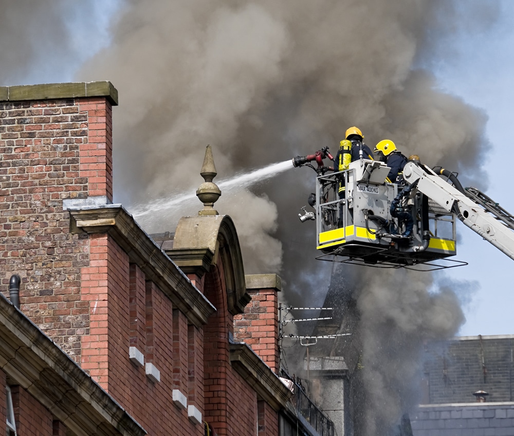 a large brick building with smoke coming out of it