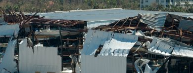 A Boat Sitting On Top Of A Wooden Dock In Front Of A Building