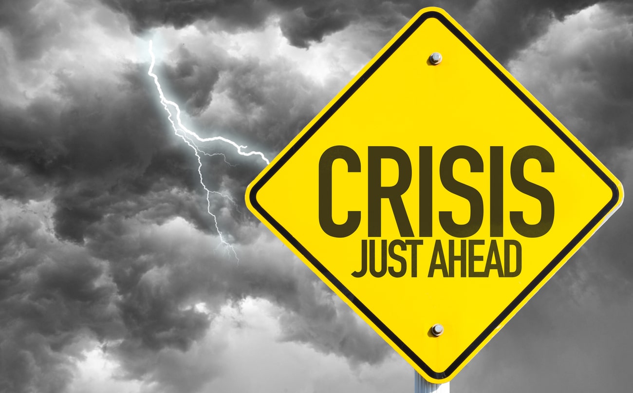 A yellow sign reading “crisis ahead” warns property owners to be prepared for any disaster, expected or unexpected.